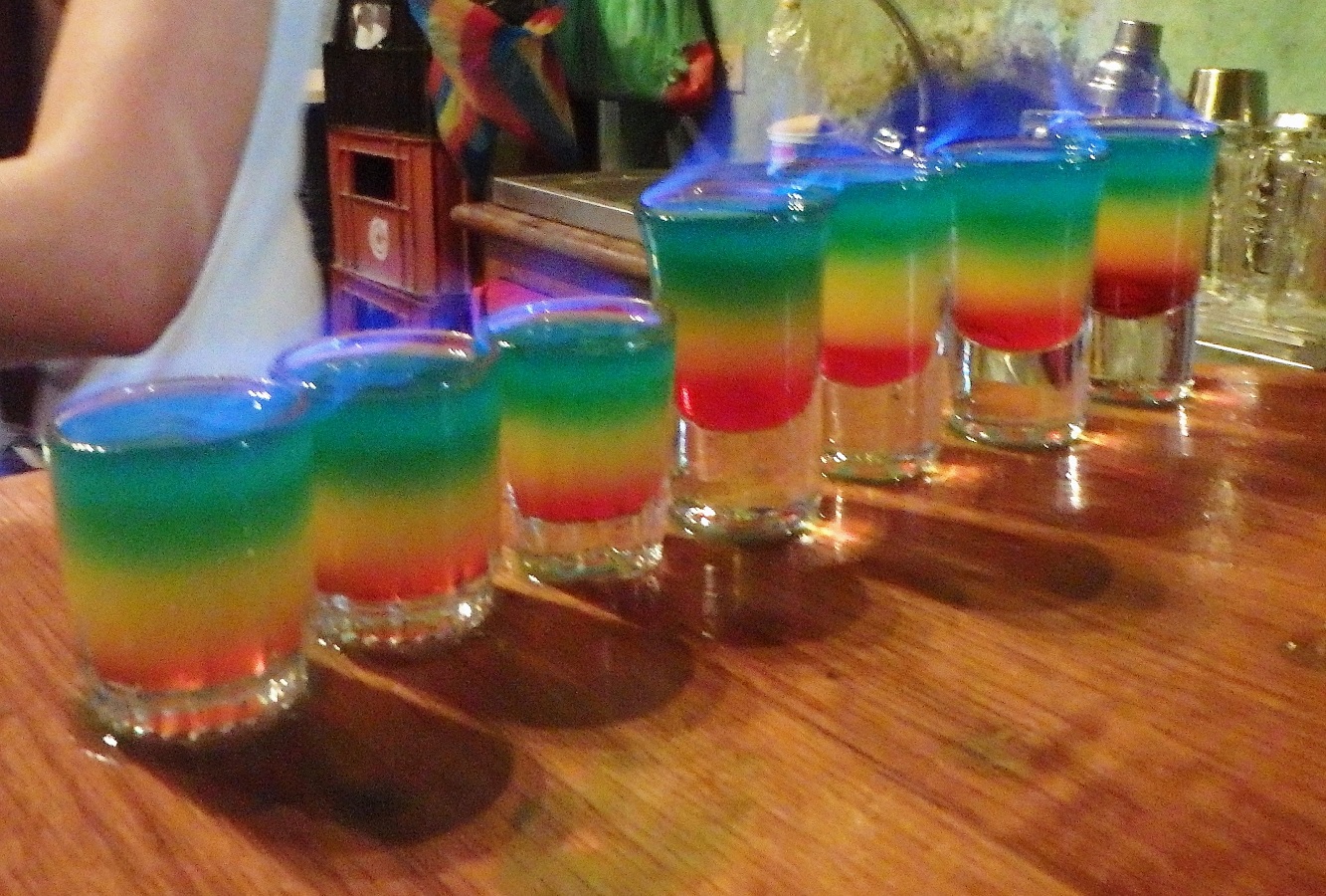 A row of rainbow-coloured shots lit on fire